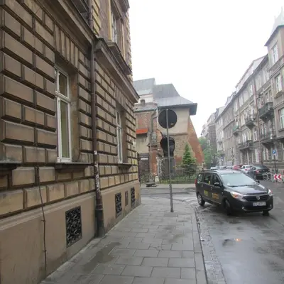 a car parked on a street next to a building at CDR in Kraków