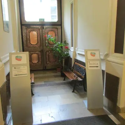a hallway with two signs in front of a door at CDR in Kraków