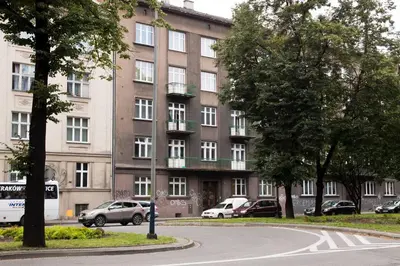 a large building with cars parked in front of it at Unique apartments Krasinskiego street in Kraków