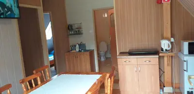 a small kitchen with a table and a bathroom at Zajazd na Podzamczu in Pieskowa Skała