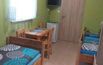 a room with a table and chairs and a dining room at Zajazd na Podzamczu in Pieskowa Skała
