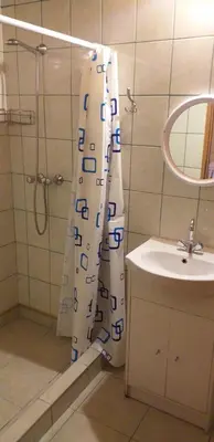 a bathroom with a shower curtain and a sink at Zajazd na Podzamczu in Pieskowa Skała
