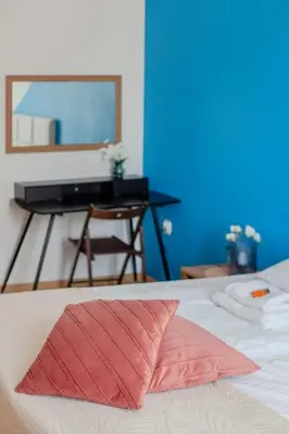 a bed with a red pillow in front of a piano at Castle View Krasinskiego Avenue in Kraków