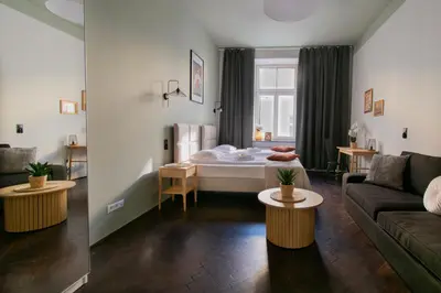 a living room with a bed and a couch at Apartments Wróblewskiego Street in Kraków
