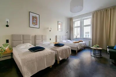 a hotel room with two beds and a window at Apartments Wróblewskiego Street in Kraków