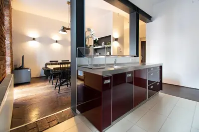 a kitchen with a counter and a dining room at Apartments Wróblewskiego Street in Kraków