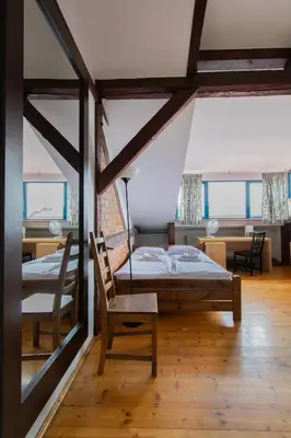 a bedroom with a bed and a table and chairs at Apartments Wróblewskiego Street in Kraków