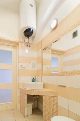 a bathroom with a sink and a mirror at Spacious Apartments Zyblikiewicza Street in Kraków