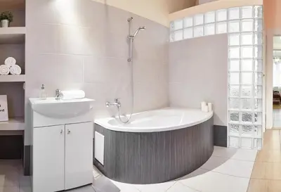a bathroom with a tub and a sink at Spacious Apartments Zyblikiewicza Street in Kraków
