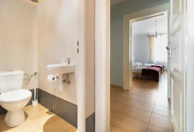 a bathroom with a toilet and a sink at Spacious Apartments Zyblikiewicza Street in Kraków