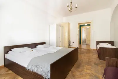 a bedroom with a large bed with white sheets at Spacious Apartments Zyblikiewicza Street in Kraków