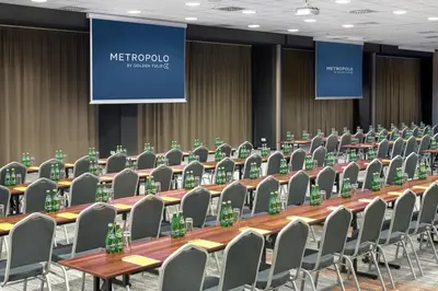 a conference room with chairs and a long table at Metropolo by Golden Tulip Krakow in Kraków
