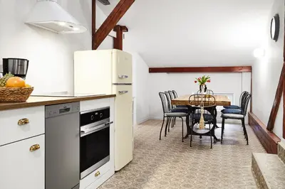 a bedroom with a bed and a wooden cabinet at Quiet Loft Michalowskiego Street in Kraków