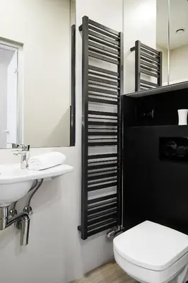 a bathroom with a sink and a toilet and a mirror at Compact Studios Słowackiego Avenue in Kraków