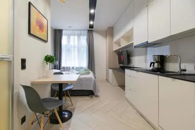 a small apartment with a kitchen and a bedroom at Compact Studios Słowackiego Avenue in Kraków