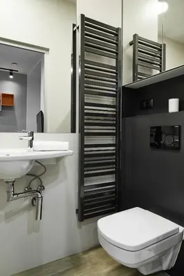 a bathroom with a toilet and a sink at Compact Studios Słowackiego Avenue in Kraków