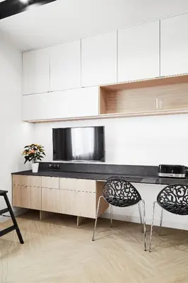 a kitchen with two chairs and a counter with a microwave at Compact Studios Słowackiego Avenue in Kraków