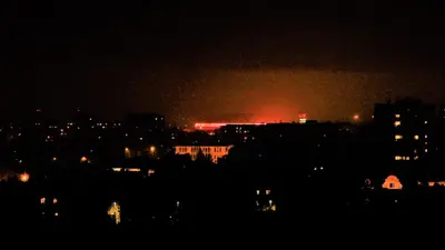 a city at night with a fire in the distance at Cracovia Panorama East Apartment Vermelo in Kraków