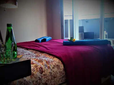 a bedroom with a bed with a bottle on it at Cracovia Panorama East Apartment Vermelo in Kraków