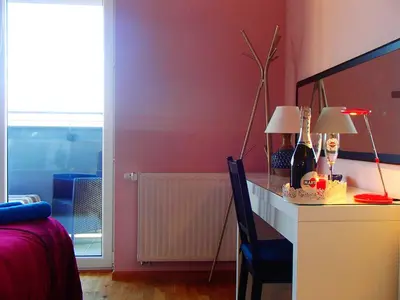 a bedroom with a desk with two lamps on it at Cracovia Panorama East Apartment Vermelo in Kraków