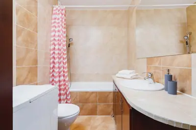 a bathroom with a sink and a toilet and a shower at Apartments Kraków Wiślane Tarasy by Noclegi Renters in Kraków