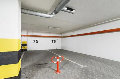 an empty room with a red object in the middle at Apartments Kraków Wiślane Tarasy by Noclegi Renters in Kraków