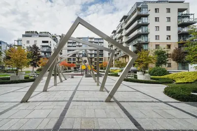 a sculpture in a city with buildings in the background at Apartments Kraków Wiślane Tarasy by Noclegi Renters in Kraków