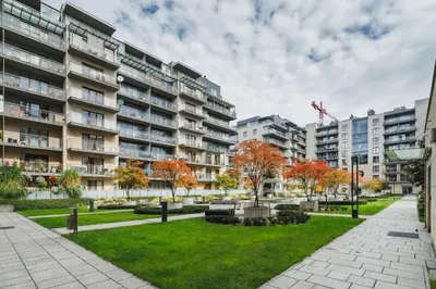 a park in front of an apartment building at Apartments Kraków Wiślane Tarasy by Noclegi Renters in Kraków