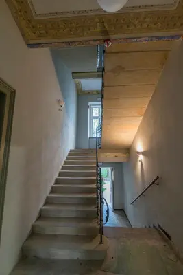 a staircase in a house with wooden ceilings at caput mundi in Kraków