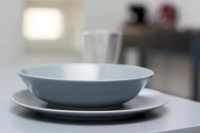 a bowl sitting on top of a plate on a counter at caput mundi in Kraków