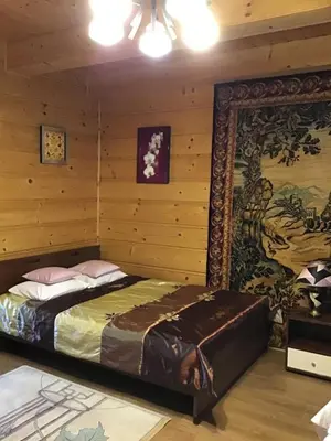 a bedroom with a bed in a wooden room at Jankówka in Wieliczka