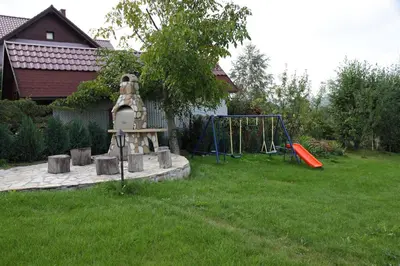 a playground in a yard with a swing set at Jankówka in Wieliczka