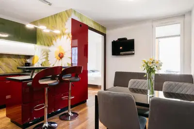 a living room with a table and chairs at Native Apartments Masarska 8 in Kraków