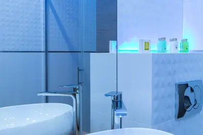 a bathroom with a sink and a toilet and a mirror at Angel Apartament in Kraków
