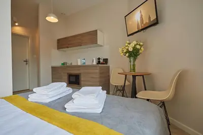 a room with a bed with white towels on it at FLORIANSKA 32 by PI Apartments in Kraków