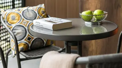 a table with a book and a bowl of apples on it at MY KRAKOW Apartments - Pianissimo in Kraków