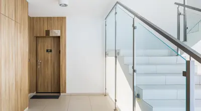 a hallway with stairs leading to a door at MY KRAKOW Apartments - Pianissimo in Kraków
