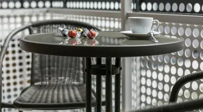 a small table with a cup of coffee and strawberries on it at MY KRAKOW Apartments - Pianissimo in Kraków
