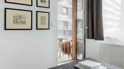 a room with a sliding glass door to a balcony at MY KRAKOW Apartments - Pianissimo in Kraków