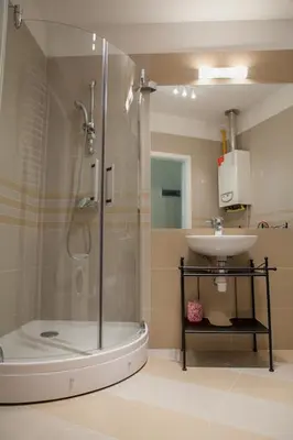 a bathroom with a shower and a sink at Pokoje Bagatela Stare Miasto in Kraków