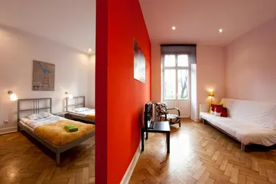 a room with two beds and a room with a bed sqor at Pokoje Bagatela Stare Miasto in Kraków