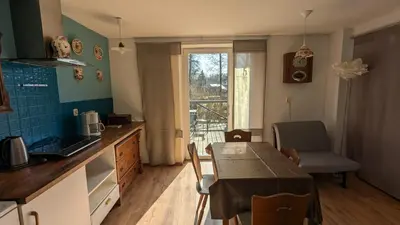a kitchen with a table and a dining room at Agroturystyka SPA in Zelków
