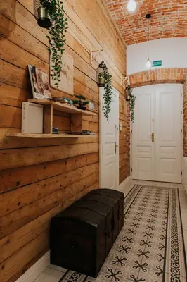 a room with a wooden wall and a white door at Old Time Apartments in Kraków