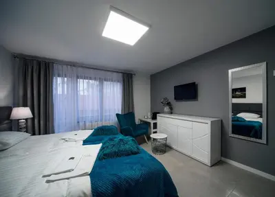 a bedroom with a large bed and a mirror at KP Claudia in Wieliczka