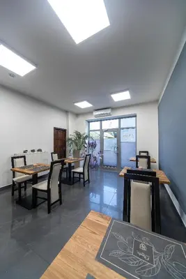 a dining room with tables and chairs and windows at KP Claudia in Wieliczka