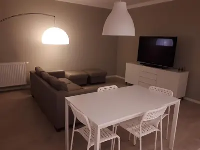 a living room with a white table and chairs at Wielicka Apartment 2 in Kraków