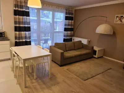 a living room with a couch and a table at Wielicka Apartment 2 in Kraków