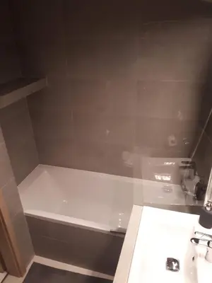 a bathroom with a white bath tub next to a sink at Wielicka Apartment 2 in Kraków