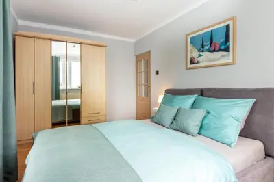 a bedroom with a large bed with blue pillows at Staymoovers - Piękna Willa w pobliżu Krakowa in Paszkówka