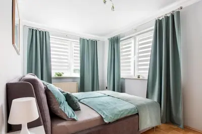 a bedroom with green curtains and a bed at Staymoovers - Piękna Willa w pobliżu Krakowa in Paszkówka